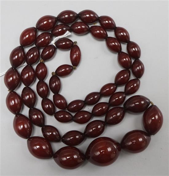 A single strand graduated simulated cherry amber bead necklace, gross 106 grams.